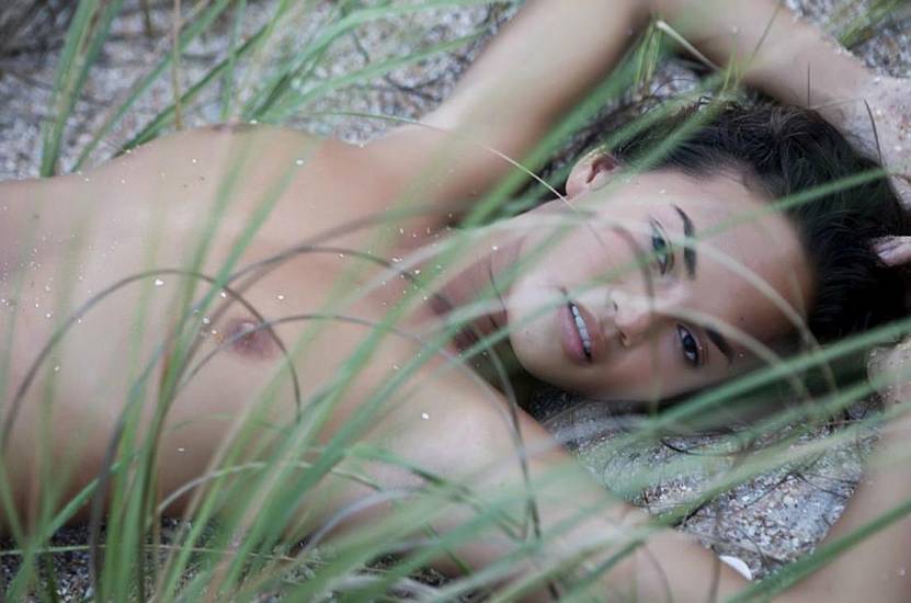 Chrissy Teigen in grass topless