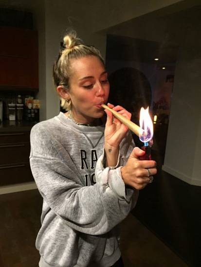 Miley Cyrus lighting the big cigarette