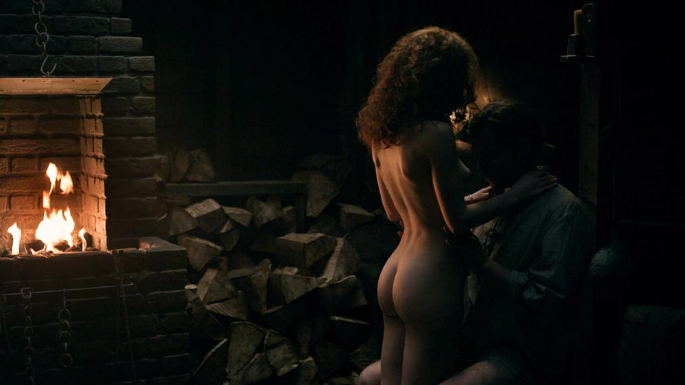 Sophie Skelton having a guy pick her up naked and carry her over to a bed a...