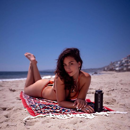 Lexy Panterra laying on the beach