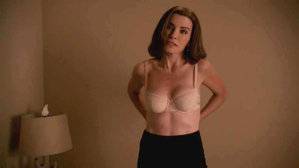Then we have Julianna Margulies unbuttoning her shirt and pulling it off to...