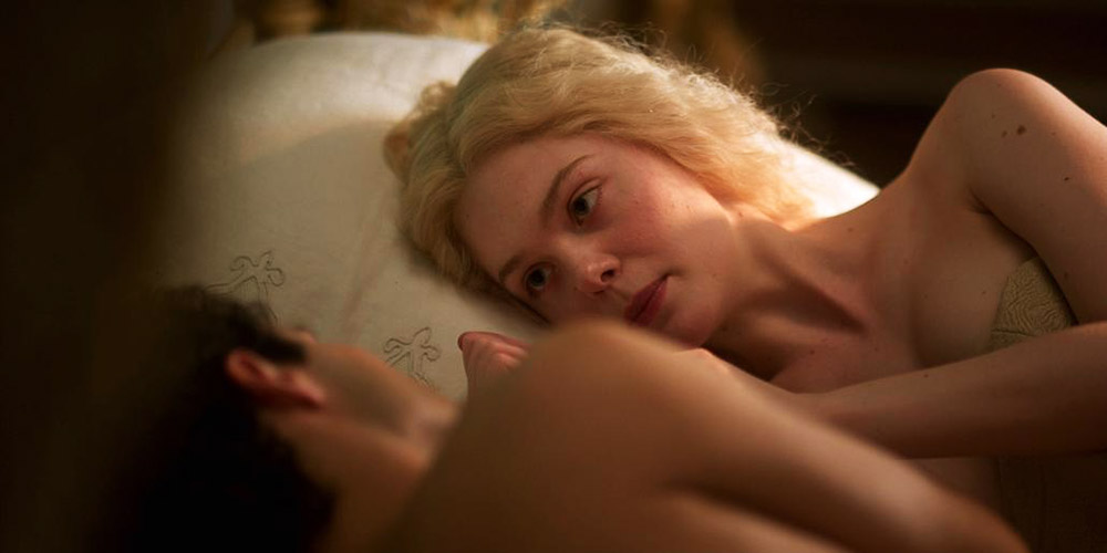Here is Elle Fanning seen from the side while lying in bed having sex with ...
