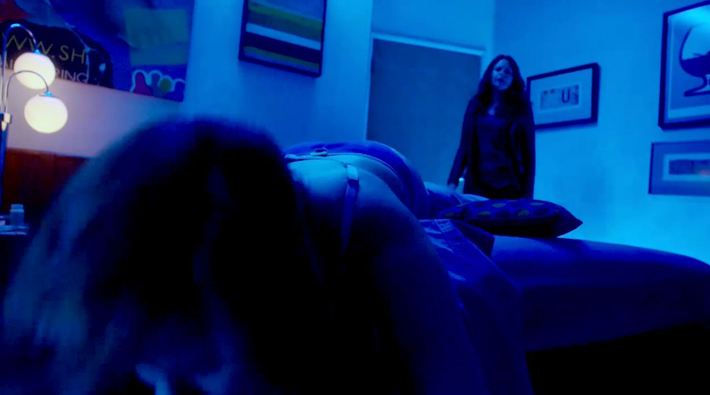 Mary Mouser is lying on her stomach very drunk. 