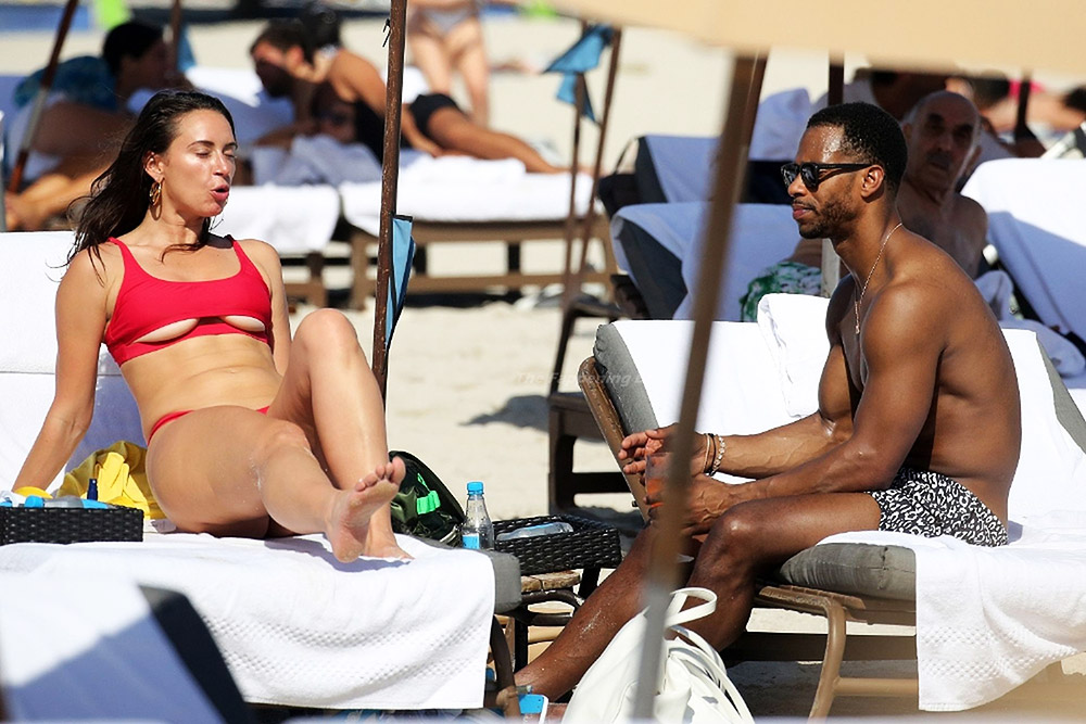 Former NFL player Victor Cruz is seen on the beach with influencer and part...