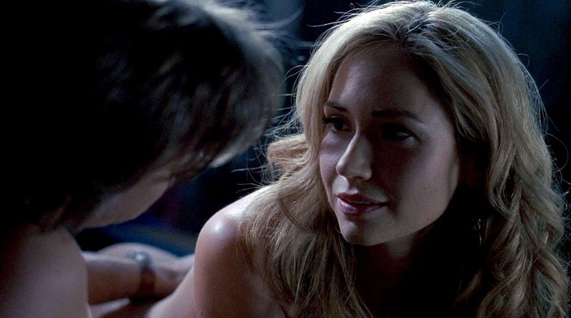 In this scene, we see Ashley Jones as she’s sitting on a pool table next to...