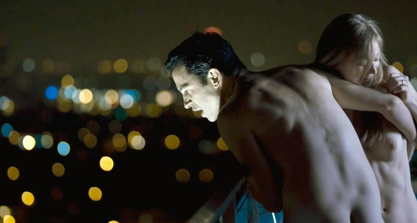 Marin Ireland walks around naked on a rooftop with a man at night, revealin...